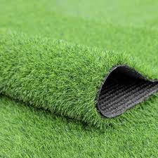 Green artificial grass turf with lifted corner showing backing