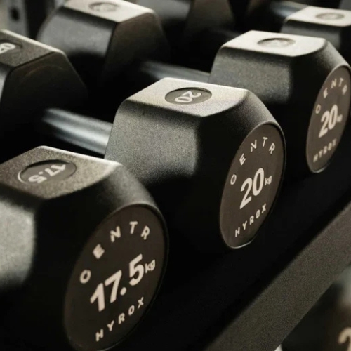 CENTR HYROX black hex dumbbells 17.5kg and 20kg on rack