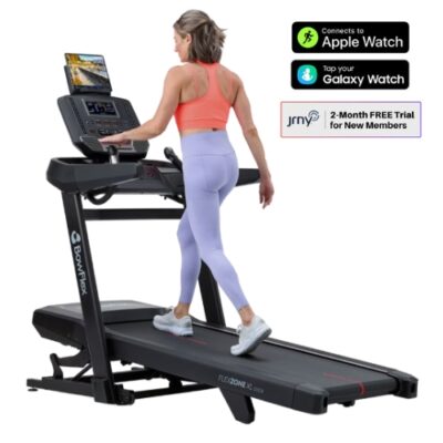 Woman walking on Bowflex treadmill with Apple and Galaxy Watch connectivity