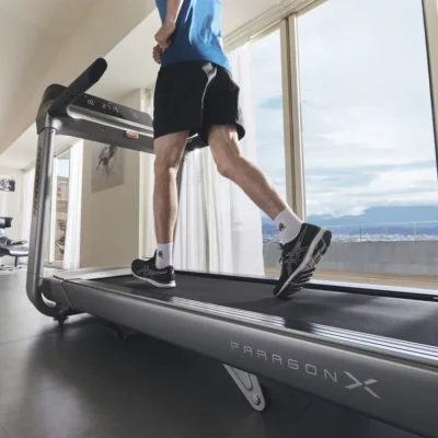 horizon | paragon x 3.25 hp Man running on Horizon Paragon X treadmill near large windows