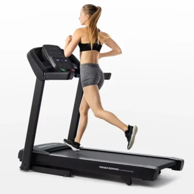 Fit woman running on Horizon treadmill with variable response cushioning