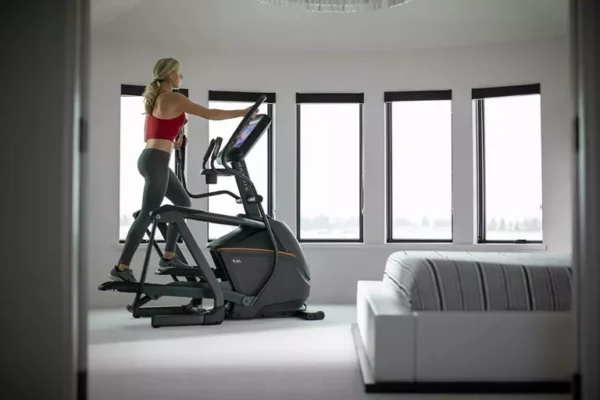matrix | a30 ascent trainer Woman exercising on elliptical trainer in bright modern home gym