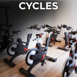 Row of black and red stationary cycles in gym studio